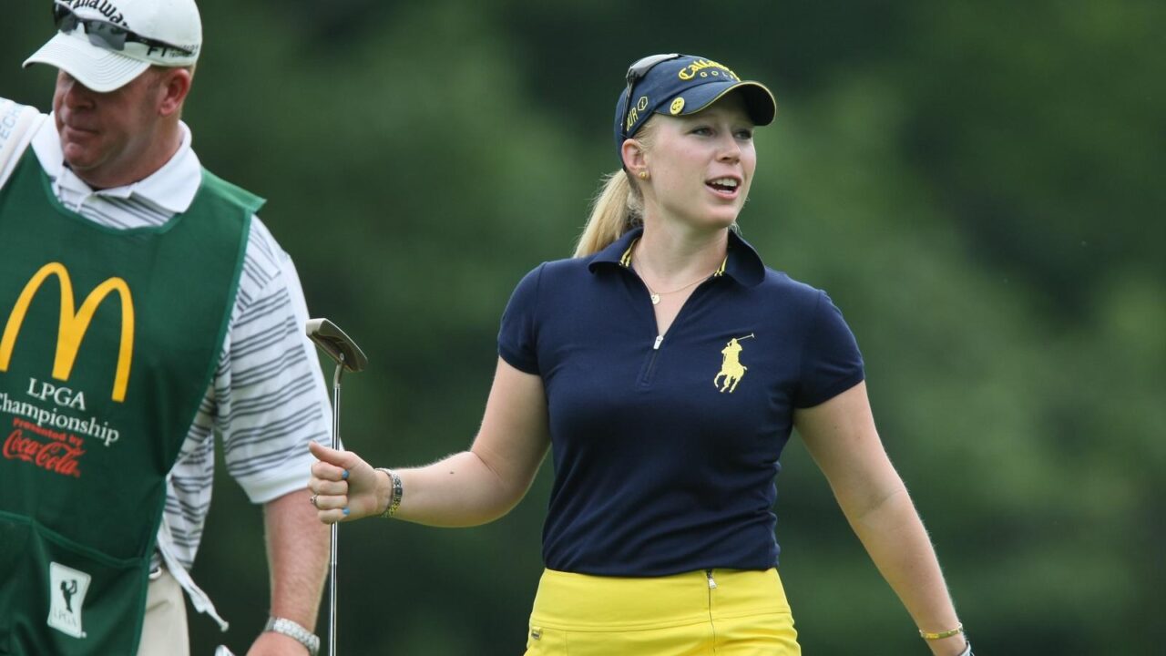 A professional golfer and caddie during a tournament