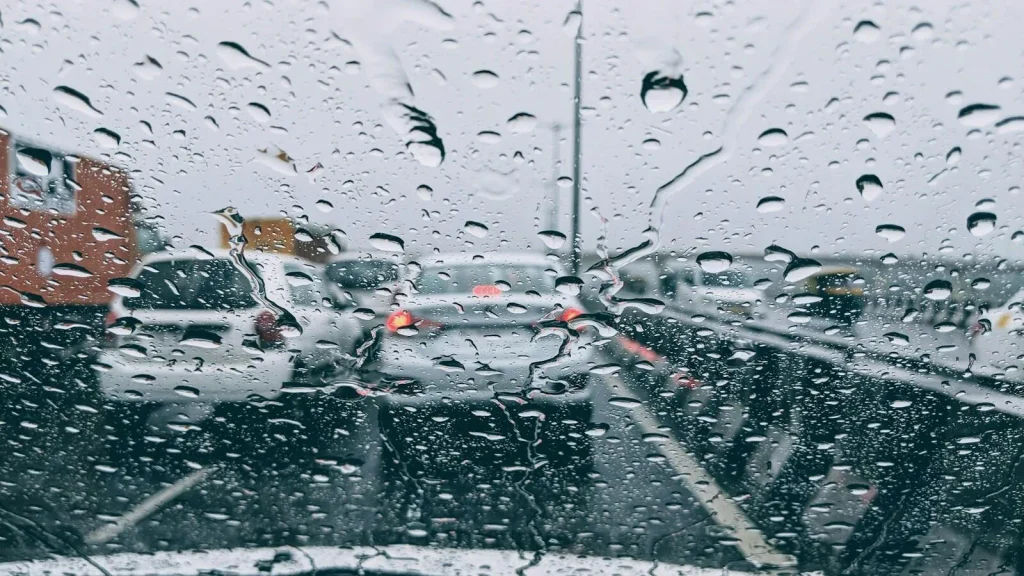 Rainy traffic viewed through a windshield